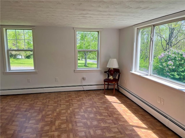 376 Upper Dutch Hill Rd, Milford, NY 13820 - unfurnished room featuring baseboard heating, a textured ceiling, and plenty of natural light