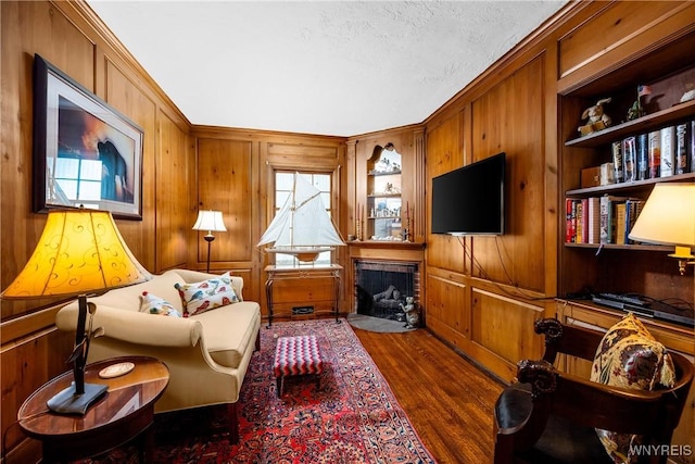 85 Windsor Ave, Buffalo, NY 14209 - living room featuring wooden walls, dark wood-style flooring, healthy amount of natural light, ornamental molding, and a textured ceiling