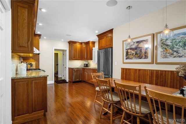 85 Windsor Ave, Buffalo, NY 14209 - kitchen with appliances with stainless steel finishes, dark wood-style floors, under cabinet range hood, brown cabinets, and recessed lighting