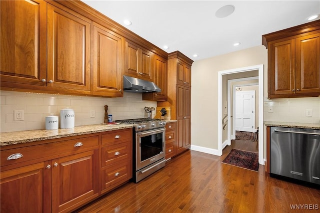 85 Windsor Ave, Buffalo, NY 14209 - kitchen featuring stainless steel appliances, under cabinet range hood, brown cabinets, light stone counters, and recessed lighting