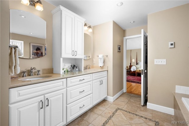85 Windsor Ave, Buffalo, NY 14209 - ensuite bathroom featuring tile patterned flooring, baseboards, double vanity, a bathtub, and recessed lighting