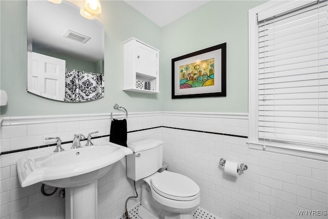 85 Windsor Ave, Buffalo, NY 14209 - bathroom with tile walls, toilet, and wainscoting