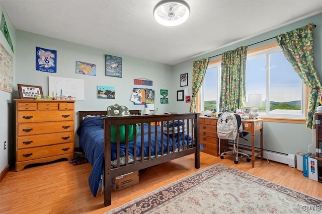 6924 Lebanon Rd, Lebanon, NY 13332 - bedroom featuring wood finished floors, a baseboard heating unit, and baseboards