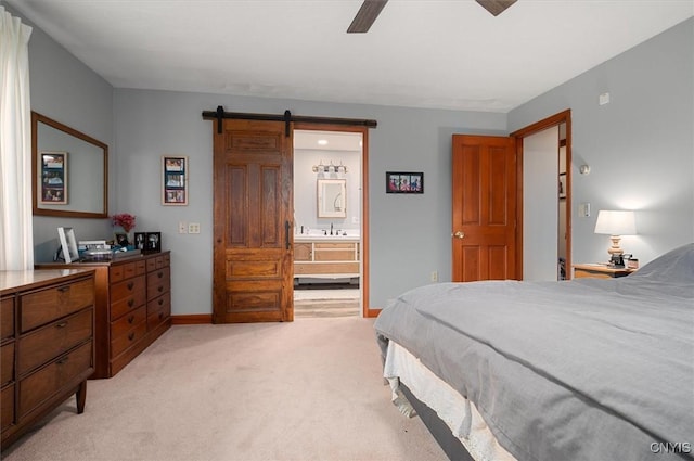 6924 Lebanon Rd, Lebanon, NY 13332 - bedroom featuring a barn door, light carpet, ensuite bathroom, baseboards, and ceiling fan