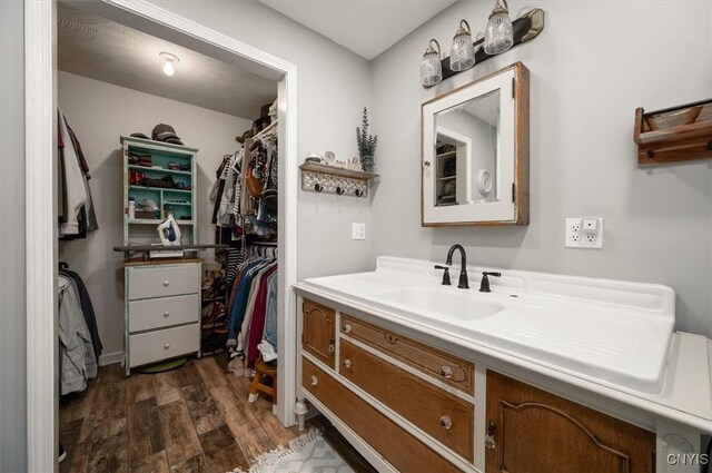 6924 Lebanon Rd, Lebanon, NY 13332 - bathroom featuring wood finished floors, vanity, and a walk in closet