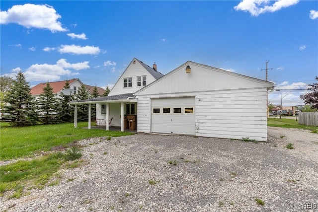 4830 Transit Rd, Cheektowaga, NY 14043 - view of front of house featuring a garage, gravel driveway, and covered porch