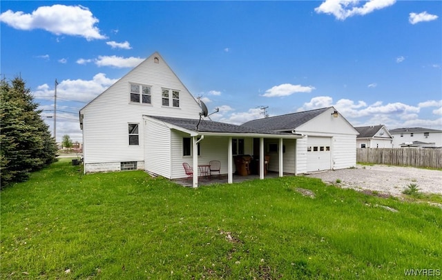 4830 Transit Rd, Cheektowaga, NY 14043 - rear view of house with a garage, gravel driveway, and a patio area