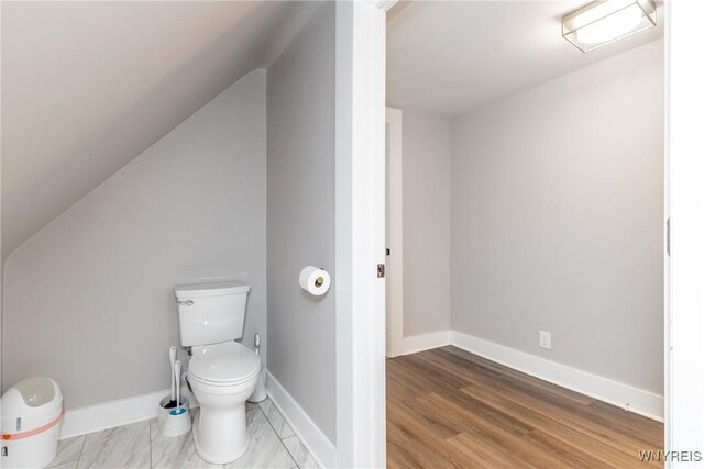4830 Transit Rd, Cheektowaga, NY 14043 - bathroom featuring toilet, baseboards, and vaulted ceiling