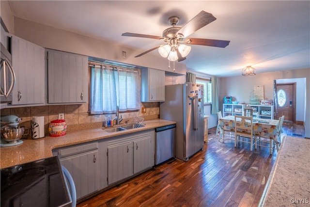 401 Palmer St, Frankfort, NY 13340 - kitchen with stainless steel appliances, a sink, dark wood-style flooring, ceiling fan, and decorative backsplash