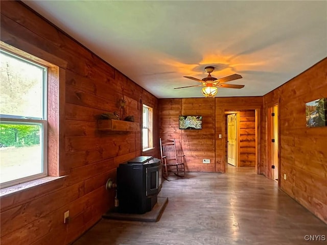 3742 State Route 8, Ohio, NY 13324 - living area featuring a wood stove, wood walls, a ceiling fan, and wood finished floors