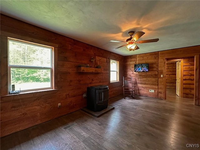 3742 State Route 8, Ohio, NY 13324 - living room featuring a wood stove, wood finished floors, ceiling fan, and wooden walls