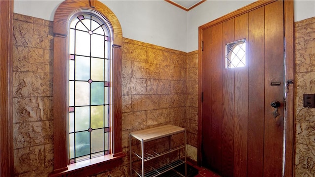 foyer entrance featuring healthy amount of natural light and tile walls