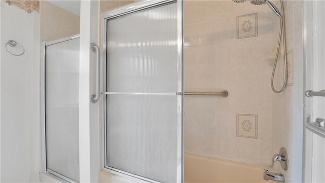 full bath featuring combined bath / shower with glass door
