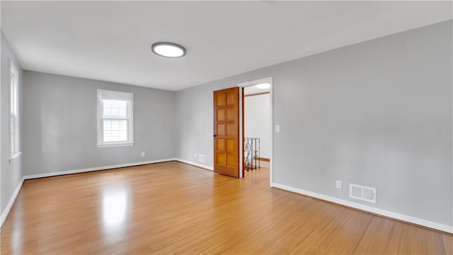 unfurnished room with wood finished floors and baseboards