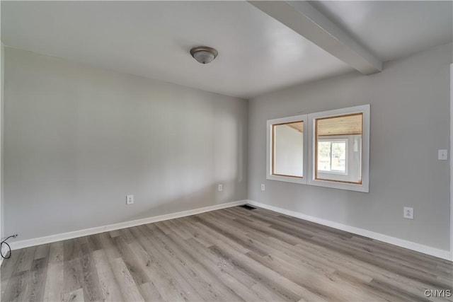 124 Haven St, Watertown-City, NY 13601 - empty room featuring wood finished floors, baseboards, and beamed ceiling