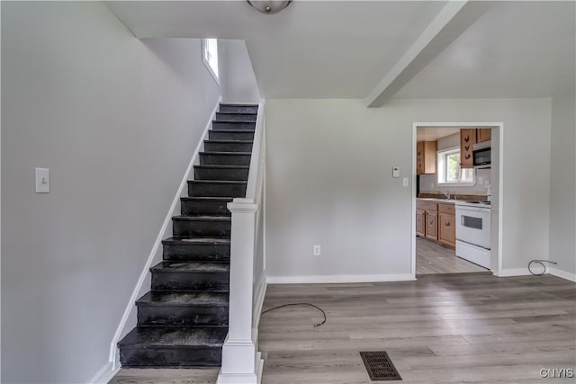 124 Haven St, Watertown-City, NY 13601 - staircase with wood finished floors, baseboards, and beam ceiling