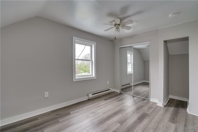 124 Haven St, Watertown-City, NY 13601 - unfurnished bedroom featuring a baseboard radiator, vaulted ceiling, wood finished floors, a closet, and baseboards