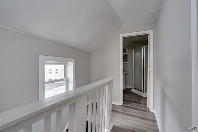 124 Haven St, Watertown-City, NY 13601 - hallway featuring an upstairs landing, lofted ceiling, light wood-type flooring, and baseboards
