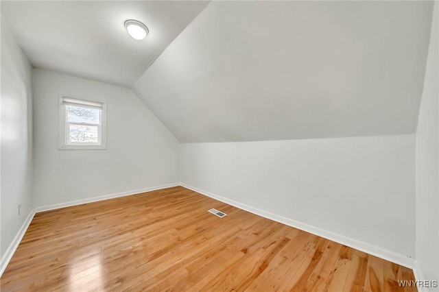 397 14th St, Buffalo, NY 14213 - additional living space featuring vaulted ceiling, baseboards, and light wood-style flooring