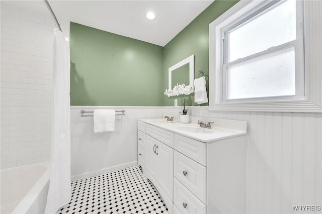 397 14th St, Buffalo, NY 14213 - full bathroom with double vanity, wainscoting, and shower / bath combo