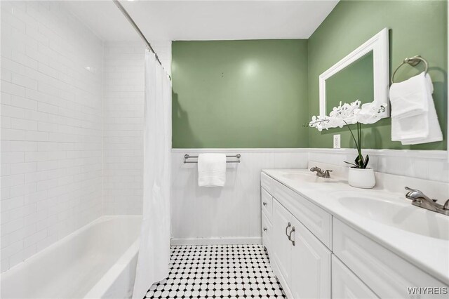 397 14th St, Buffalo, NY 14213 - bathroom with double vanity, a wainscoted wall, shower / bath combo with shower curtain, and tile patterned flooring