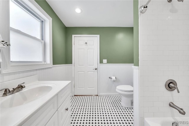 397 14th St, Buffalo, NY 14213 - bathroom with a wainscoted wall, toilet, vanity, and washtub / shower combination