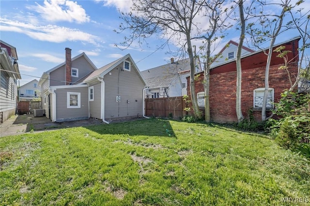397 14th St, Buffalo, NY 14213 - back of property featuring central AC unit, a chimney, and a patio