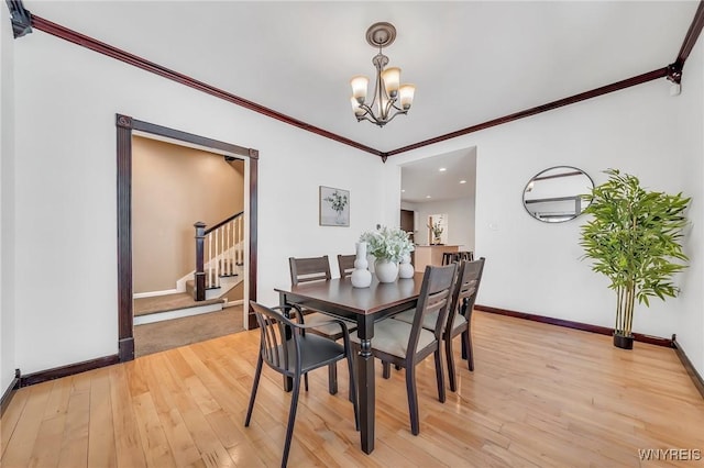 397 14th St, Buffalo, NY 14213 - dining room with light wood-style flooring, stairway, a chandelier, baseboards, and crown molding