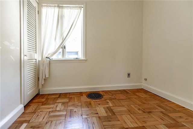spare room featuring baseboards