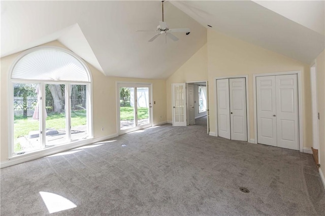 unfurnished living room featuring a ceiling fan, carpet, baseboards, and high vaulted ceiling