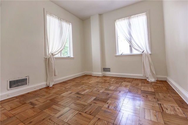 unfurnished room with baseboards