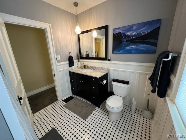 536 Potomac Ave, Buffalo, NY 14222 - bathroom with wainscoting, toilet, a decorative wall, and vanity