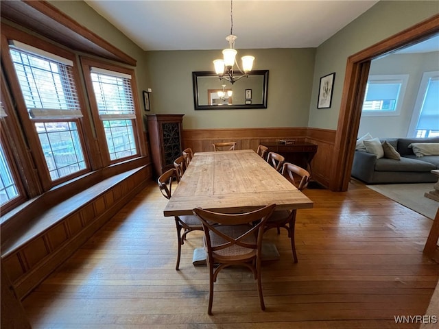 536 Potomac Ave, Buffalo, NY 14222 - dining space with hardwood / wood-style floors, a chandelier, and a wainscoted wall