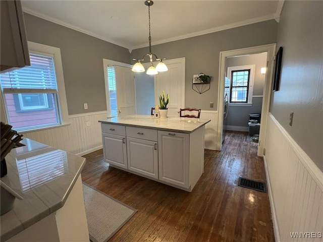 536 Potomac Ave, Buffalo, NY 14222 - kitchen with wainscoting, dark wood finished floors, a center island, white cabinets, and ornamental molding