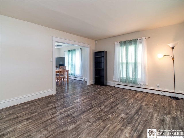 78 Benson St, Jamestown, NY 14701 - empty room featuring wood finished floors, a baseboard heating unit, and baseboards
