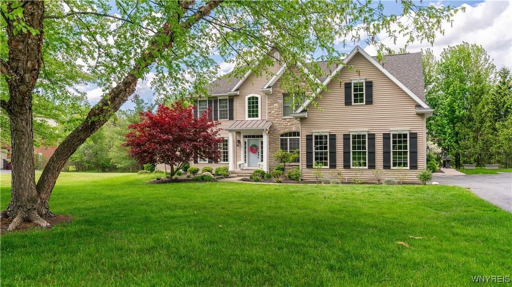 20 Woodthrush Trl, Orchard Park, NY 14127 - view of front of house with a front lawn, stone siding, and roof with shingles
