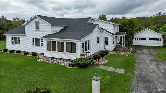 view of property exterior with an outdoor structure, roof with shingles, a garage, and a yard