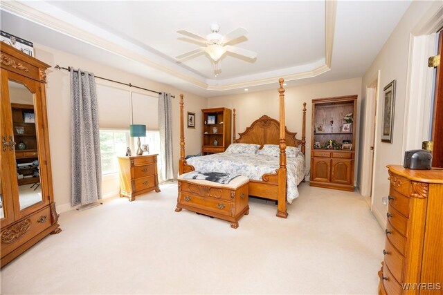 5067 William St, Lancaster, NY 14086 - bedroom featuring light colored carpet, a tray ceiling, and a ceiling fan