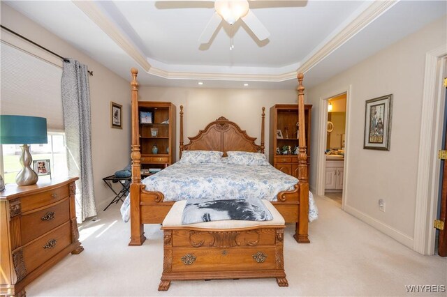 5067 William St, Lancaster, NY 14086 - bedroom featuring light colored carpet, a tray ceiling, ensuite bath, a ceiling fan, and baseboards