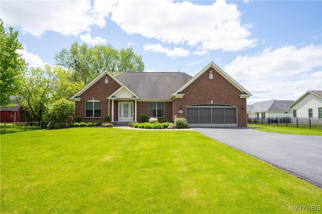 5067 William St, Lancaster, NY 14086 - view of front of home with driveway, brick siding, and a garage
