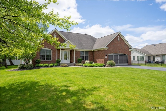 5067 William St, Lancaster, NY 14086 - view of front of property featuring driveway, brick siding, an attached garage, and french doors