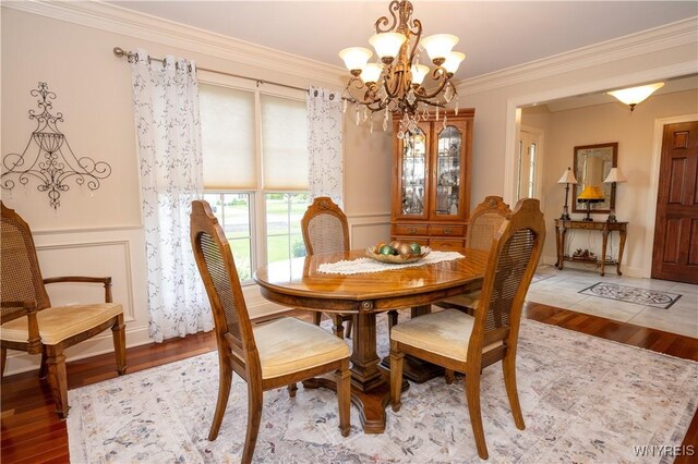 5067 William St, Lancaster, NY 14086 - dining room with a chandelier, wood finished floors, and ornamental molding