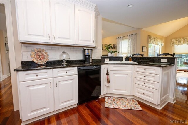 5067 William St, Lancaster, NY 14086 - kitchen featuring dishwasher, dark wood-type flooring, vaulted ceiling, a peninsula, and tasteful backsplash
