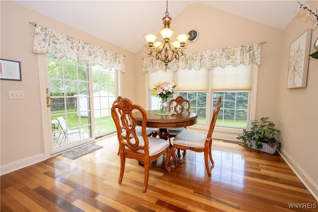 5067 William St, Lancaster, NY 14086 - dining area with a chandelier, lofted ceiling, plenty of natural light, and wood finished floors