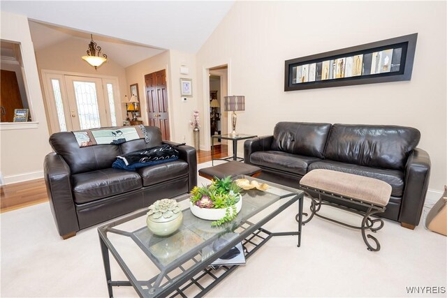 5067 William St, Lancaster, NY 14086 - living room featuring vaulted ceiling, baseboards, and wood finished floors