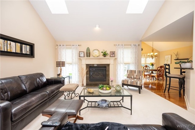 5067 William St, Lancaster, NY 14086 - living area featuring vaulted ceiling, a skylight, a premium fireplace, a chandelier, and wood finished floors