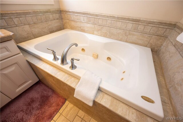 5067 William St, Lancaster, NY 14086 - bathroom featuring a whirlpool tub, tile patterned flooring, and vanity