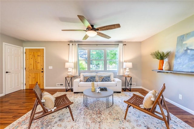 living room with wood finished floors, baseboards, and a ceiling fan