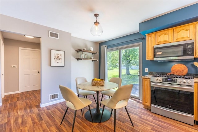 dining space with wood finished floors and baseboards