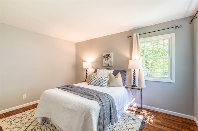 bedroom featuring baseboards and wood finished floors